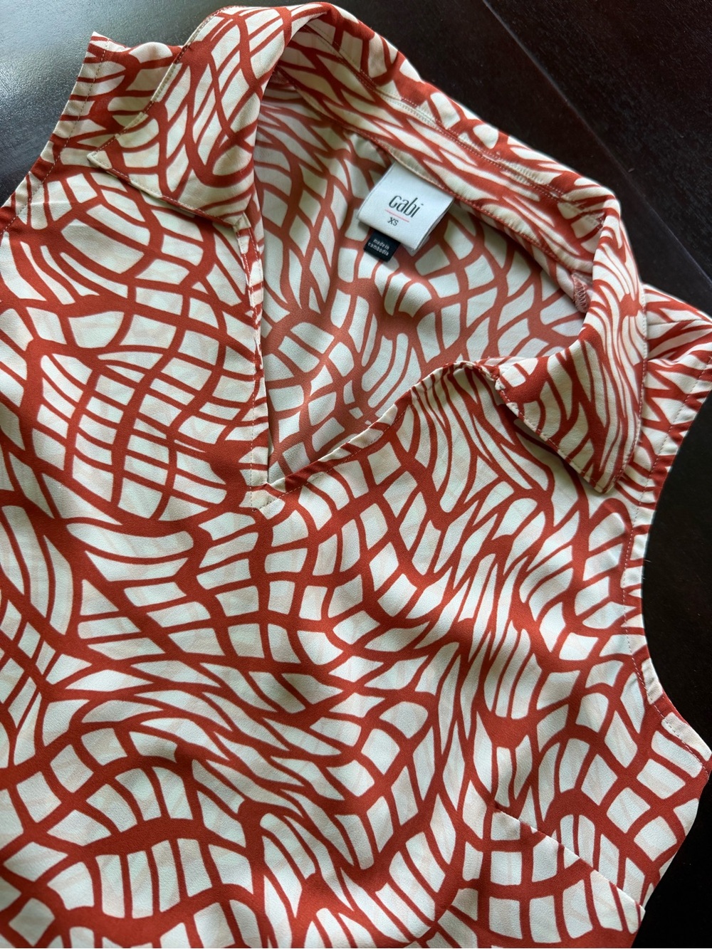 CAbi Sleeveless V-Neck Blouse in Rust and Cream Abstract Print